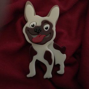 ACRYLIC/RESIN SPOTTED COMIC DOG. Back locking safety latch.